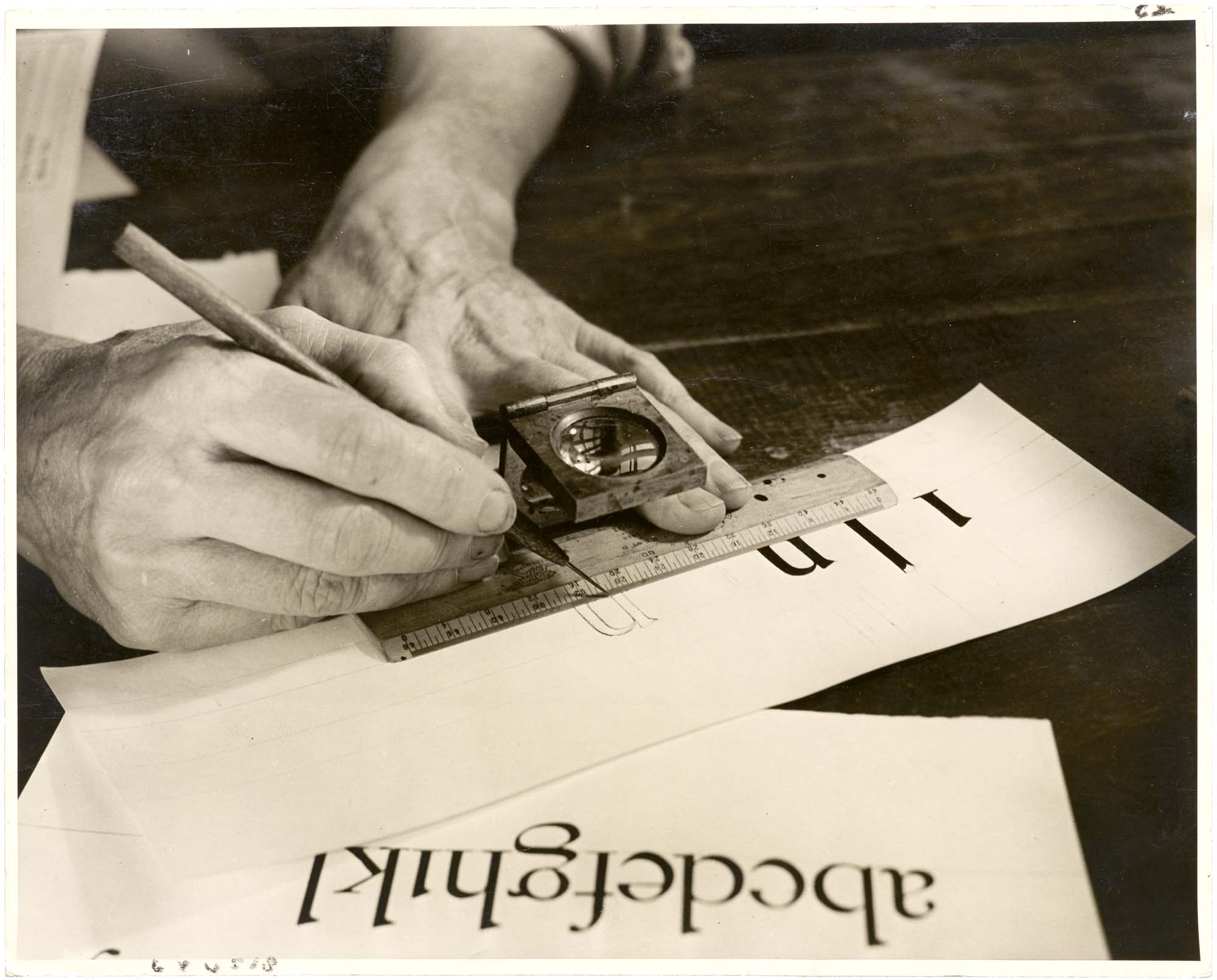 Photo of Dwiggins drawing letters