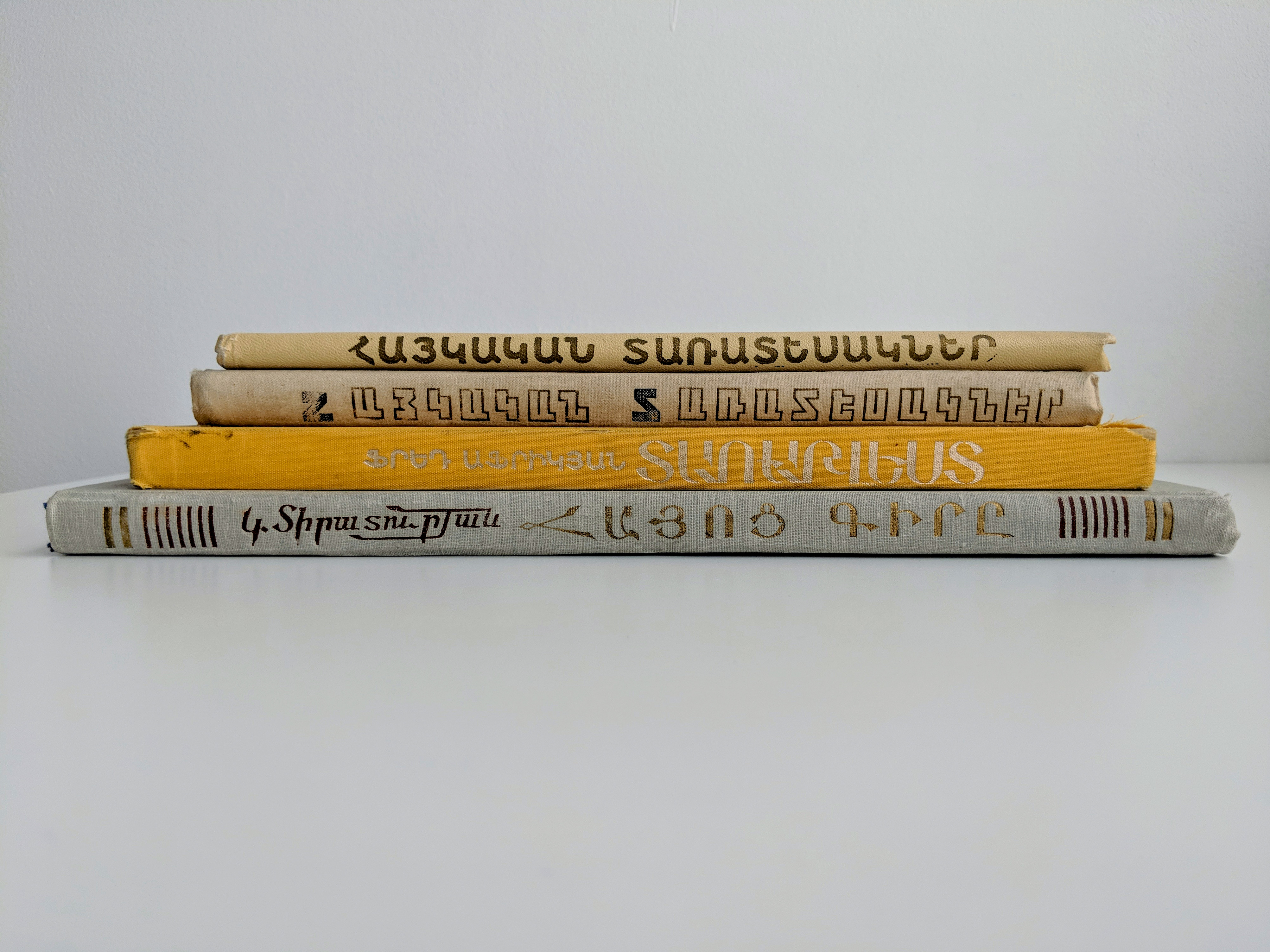 Photograph of a stack of lettering manuals, showing the spines.